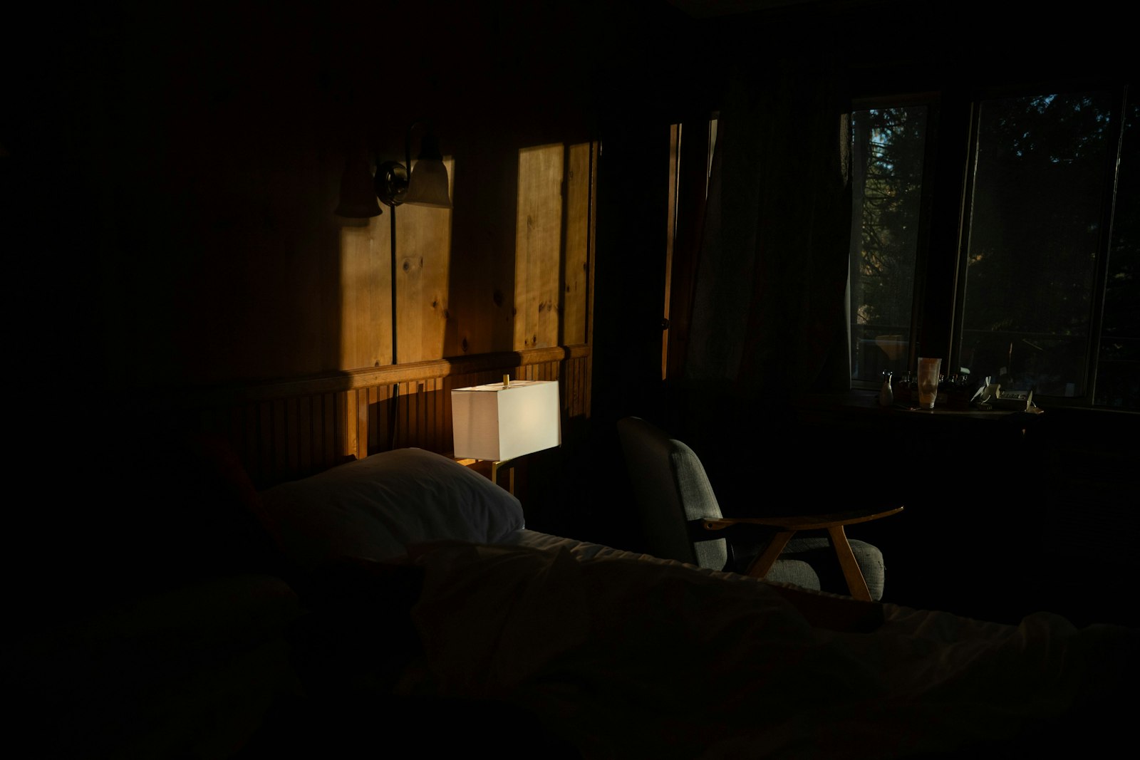 The bedroom in the evening, with the storage wall flush to the paint