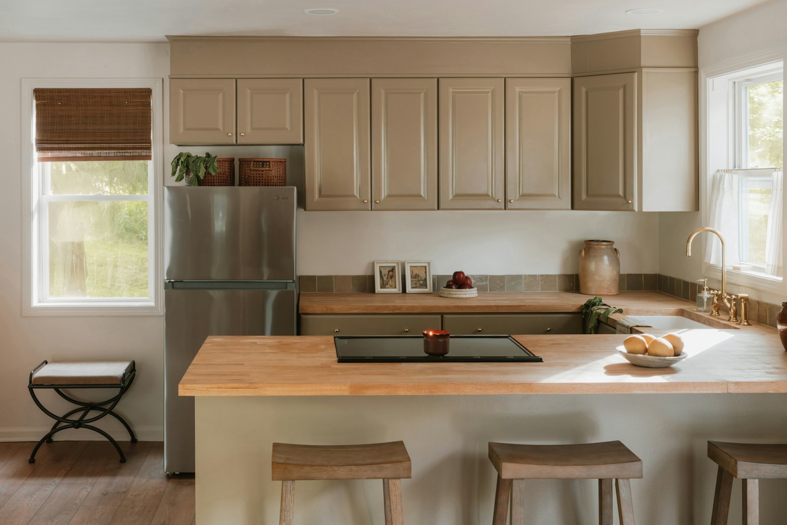 The finished kitchen with light wood cabinets and an island